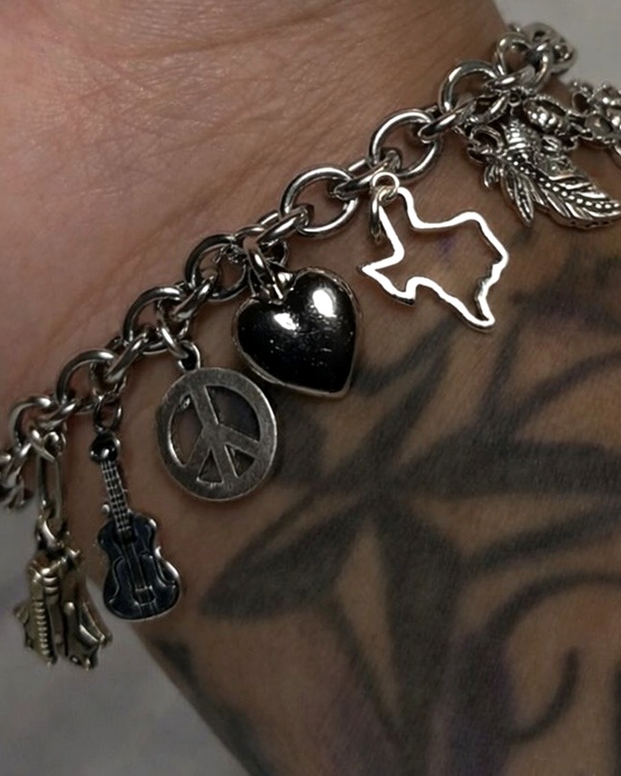 A GRWNG charm bracelet worn on the wrist